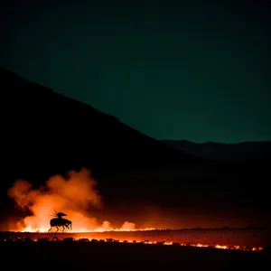 Sunset Over Volcanic Landscape: Fiery Celestial Display