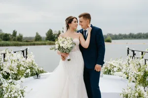 Happy newlywed couple celebrating love outdoors with flowers