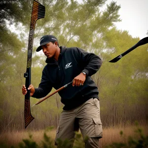 Male Golfer Swinging Club on Green