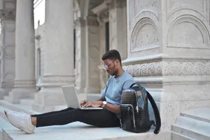 Happy businessman working on laptop in office