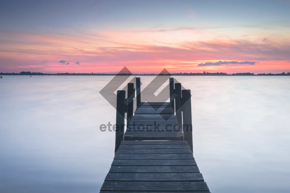 Picture of Tropical holiday escape on wooden pier overlooking ocean.