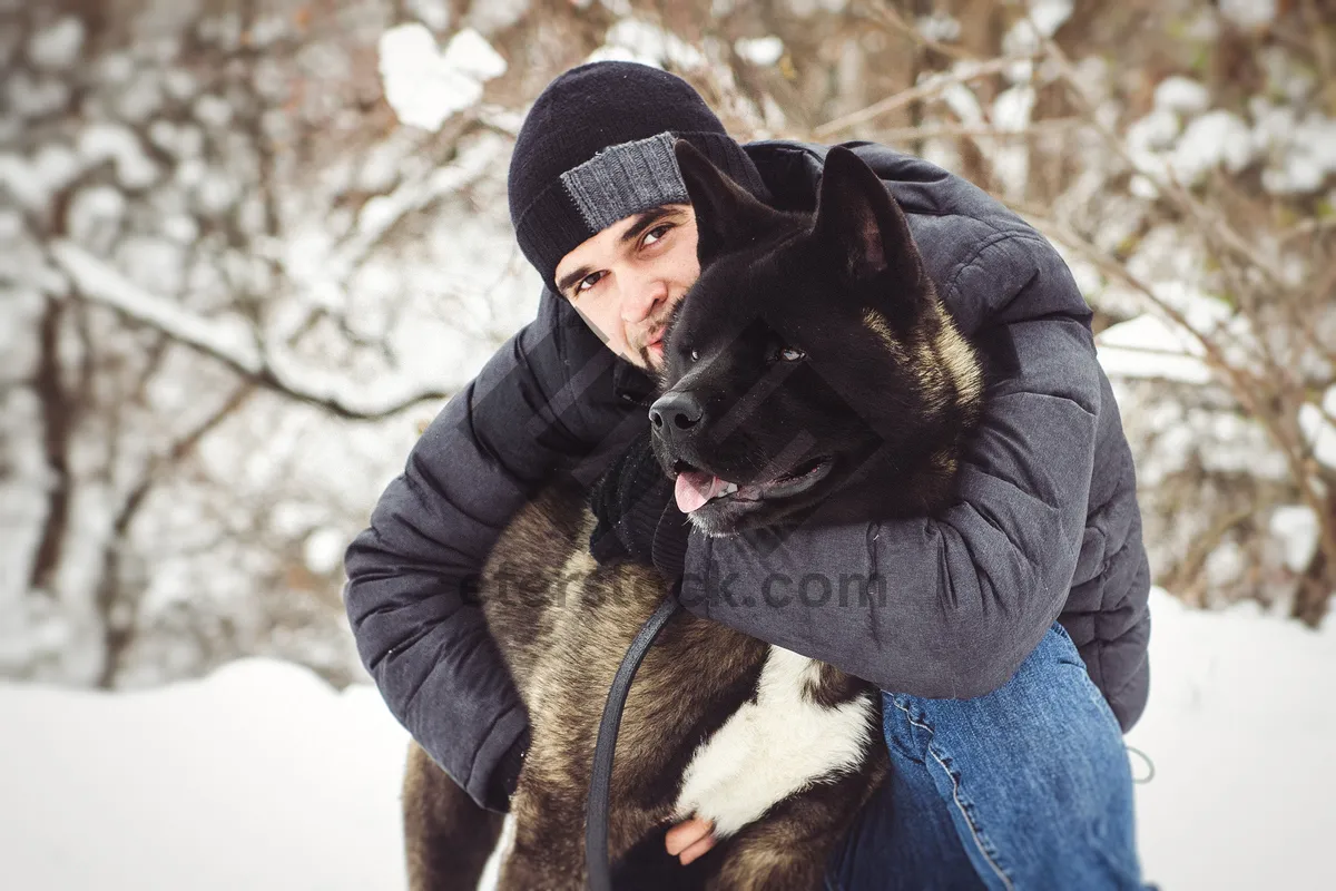 Picture of Happy Child with Cute Pet Dog in Winter