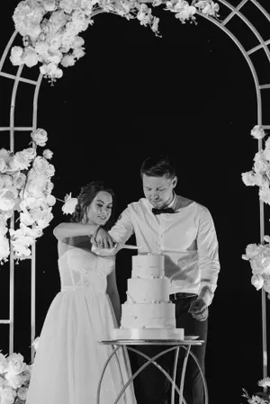 Happy couple celebrating wedding ceremony with flower bouquet.