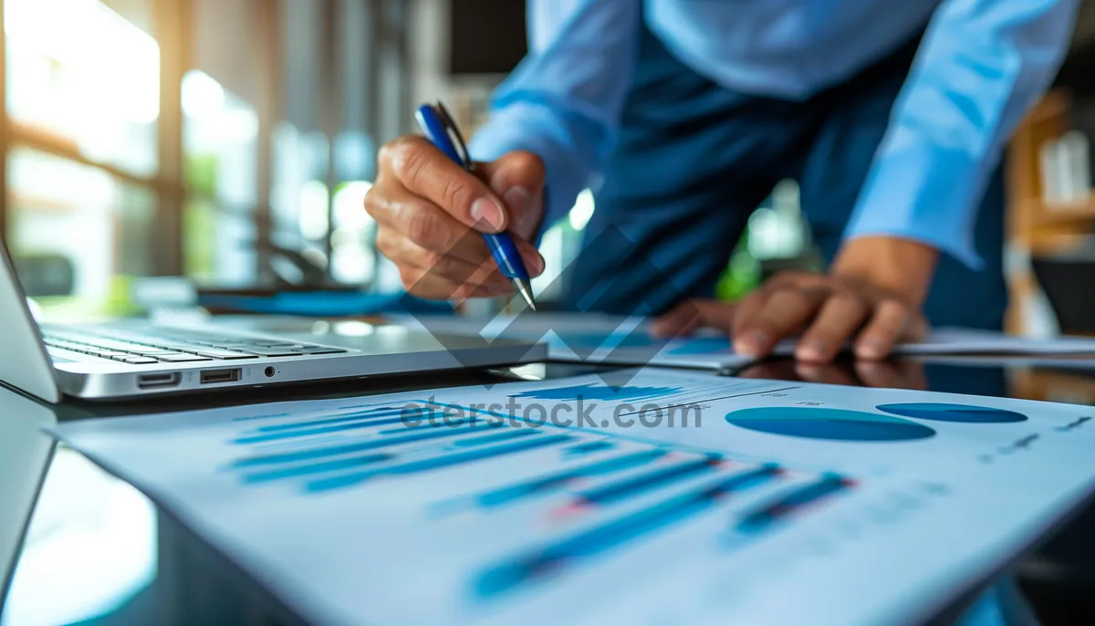 Picture of Corporate businessman working on laptop at office desk.