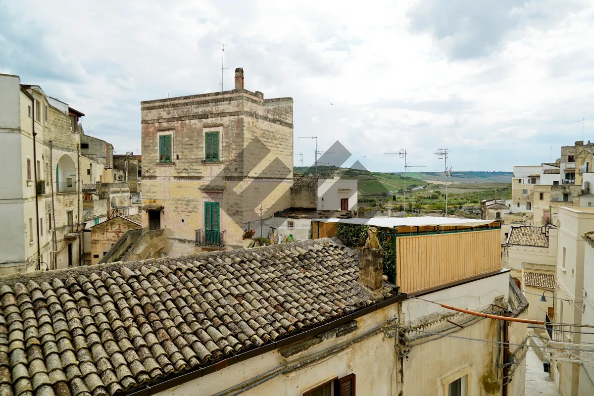 Picture of Medieval stone castle with tile roof in historic town.