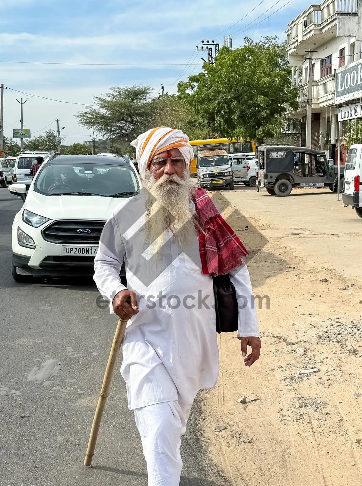 Picture of Man with crutch walking with staff