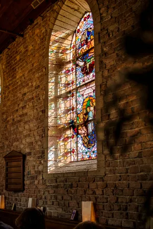 Historic cathedral window with intricate stone mosaic artwork.