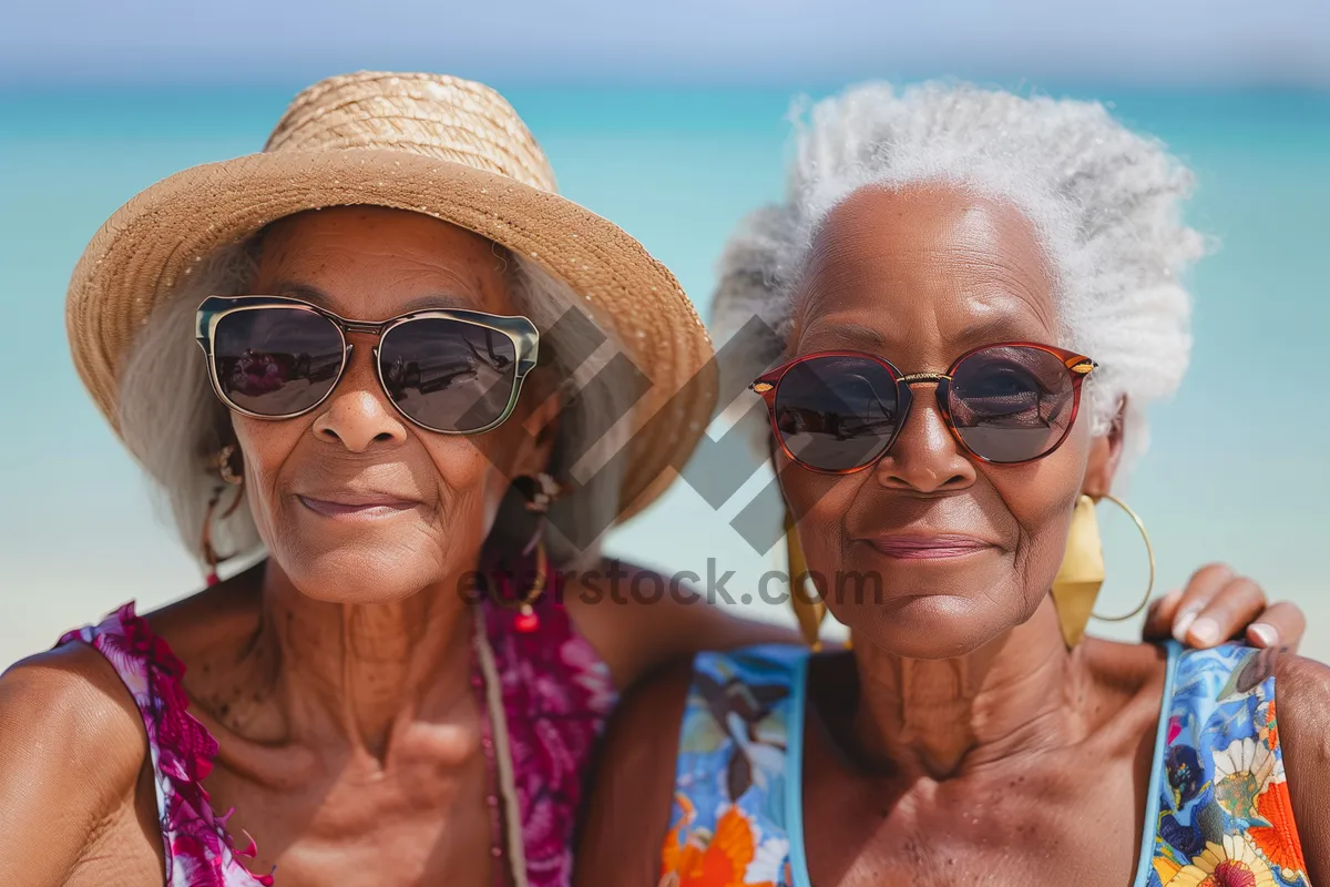 Picture of Happy couple wearing sunglasses at the beach vacation.