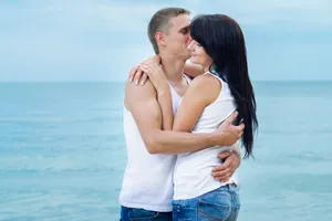 Happy couple enjoying romantic beach vacation together.