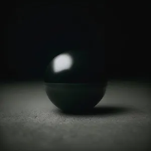 Black Egg on Pool Table with Game Equipment