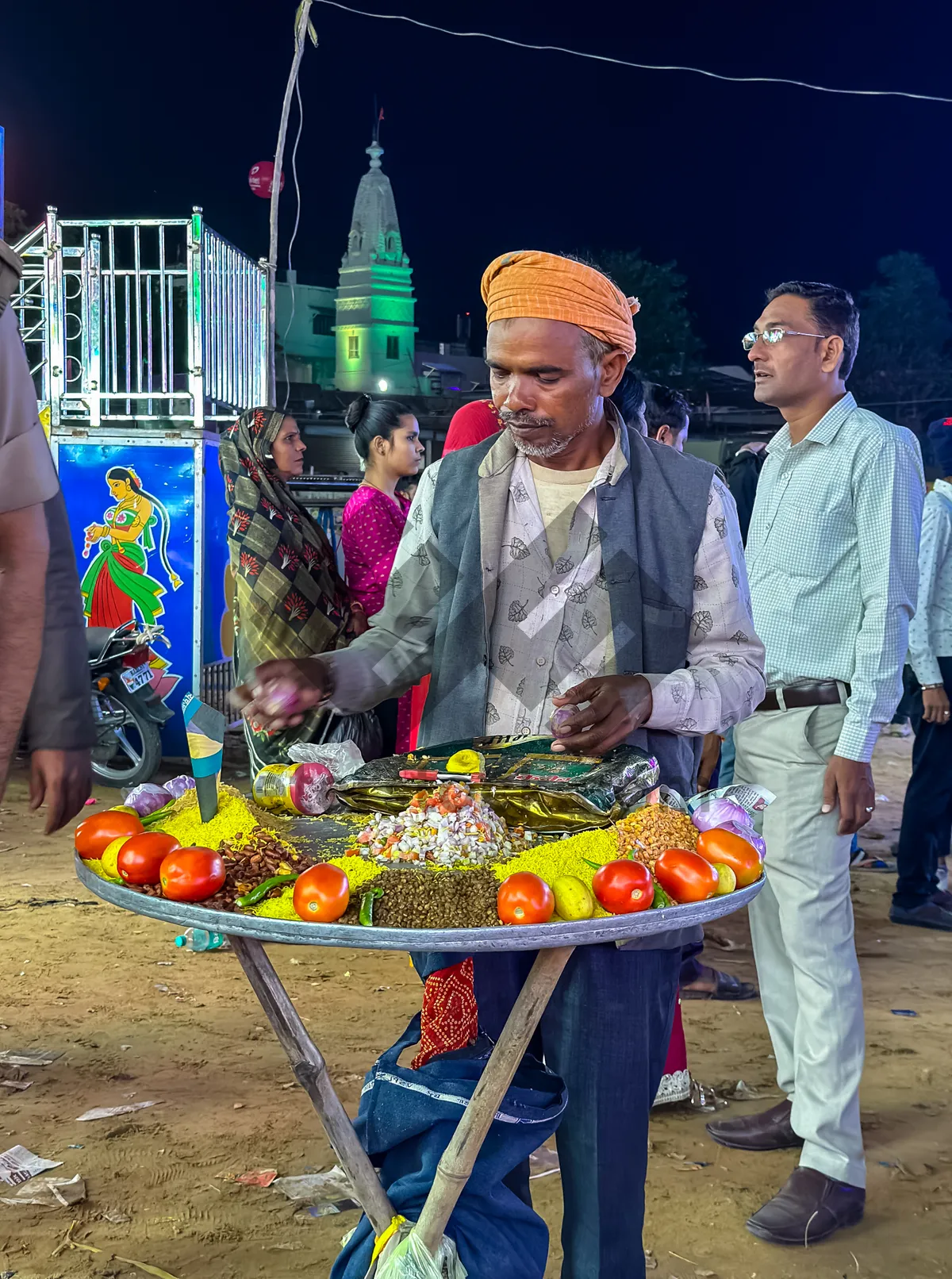 Picture of Happy fruit seller with handcart at outdoor market.