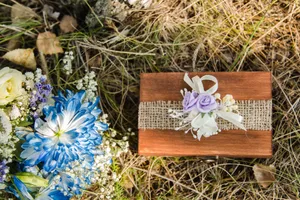 Container tray with cup, flower and rubbish.