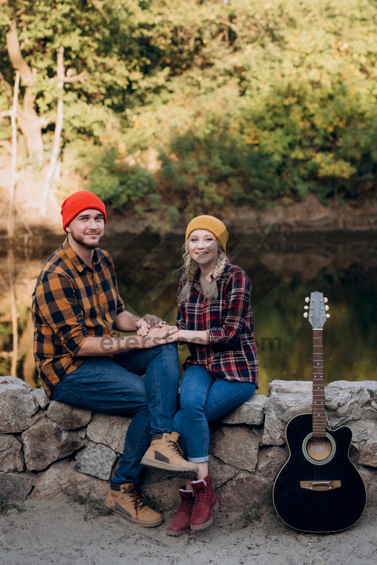 Picture of Happy couple hiking in autumn park with backpack