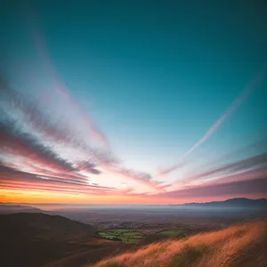 Vibrant Sunset over Rural Meadow