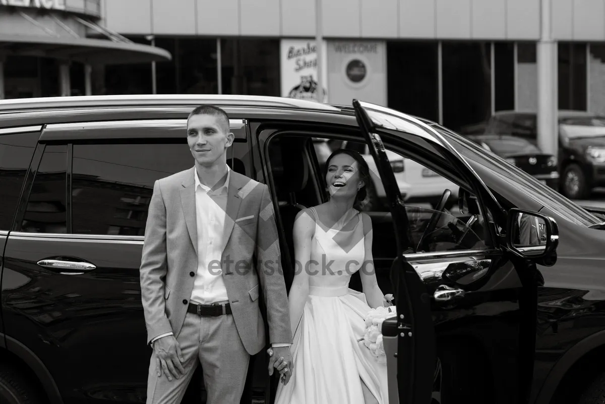 Picture of Happy couple in wedding limousine smiling and sitting.