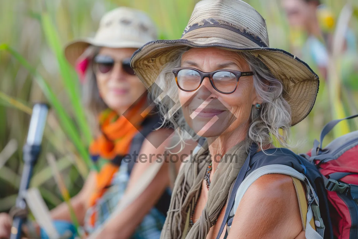 Picture of Smiling woman in stylish sunglasses and hat outdoors