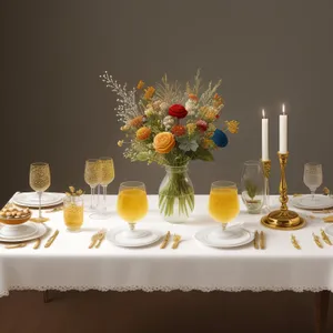 Luxury dining table setting with candles and wine.