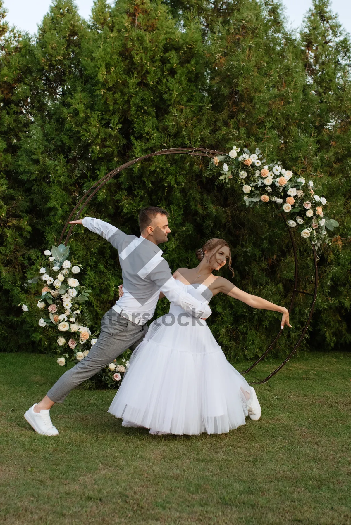 Picture of Happy bride and groom with bouquet on wedding day