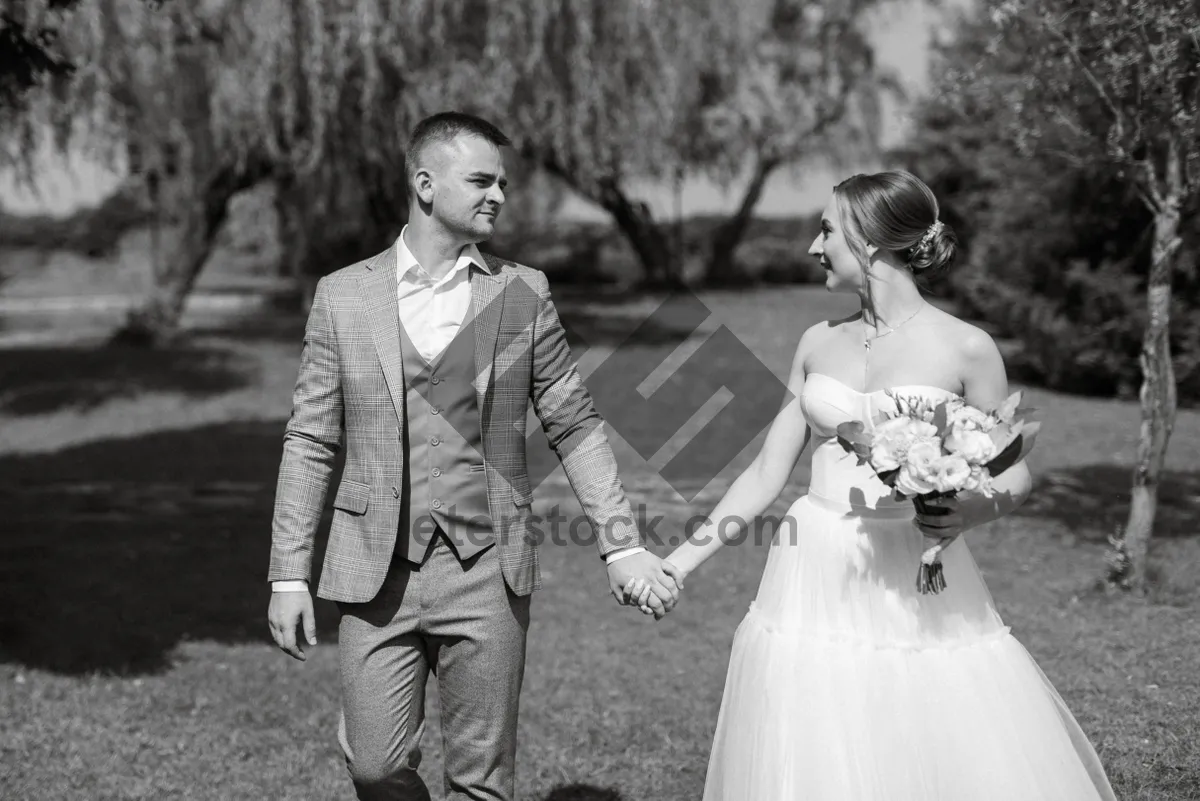 Picture of Happy Couple on Their Wedding Day Smiling Outdoors