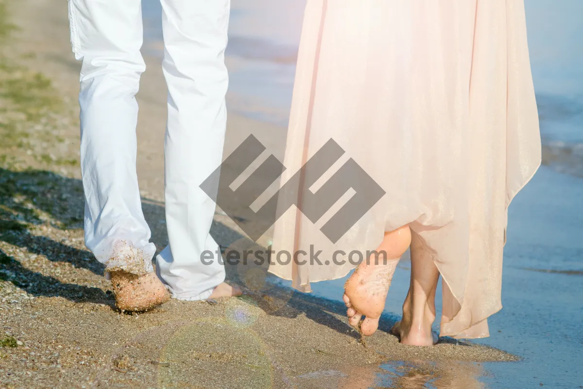 Picture of Adult man relaxing on beach with crossed legs on pad