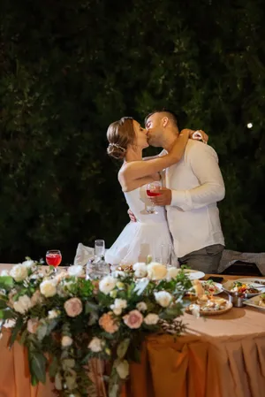 Happy couple celebrating their summer wedding with flowers