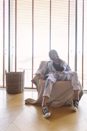 Happy man sitting in rocking chair at home