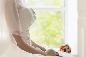 Attractive smiling bride portrait at home in spiritual attire.