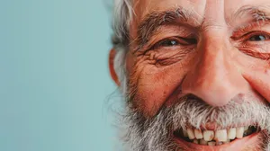 Happy elderly man with beard and mustache smiling portrait.