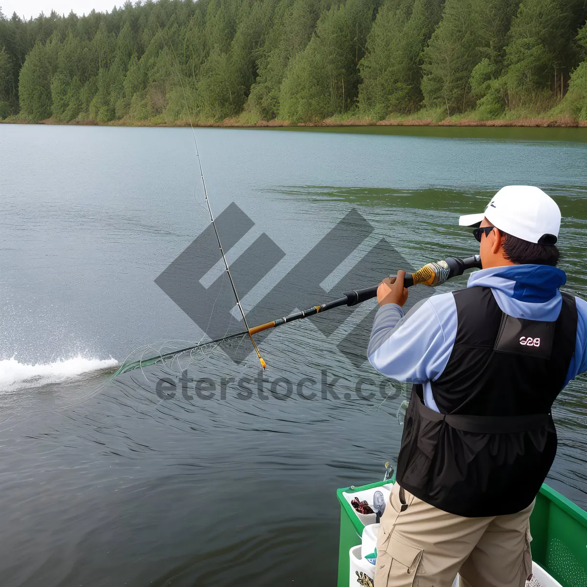 Picture of Summer Fishing Fun: Man Reeling in a Catch