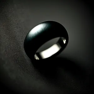 Elegant Black Ring with Reflection in Lamp Light