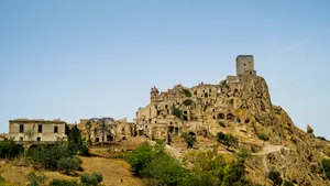 Historic medieval castle fortress against city skyline and sky