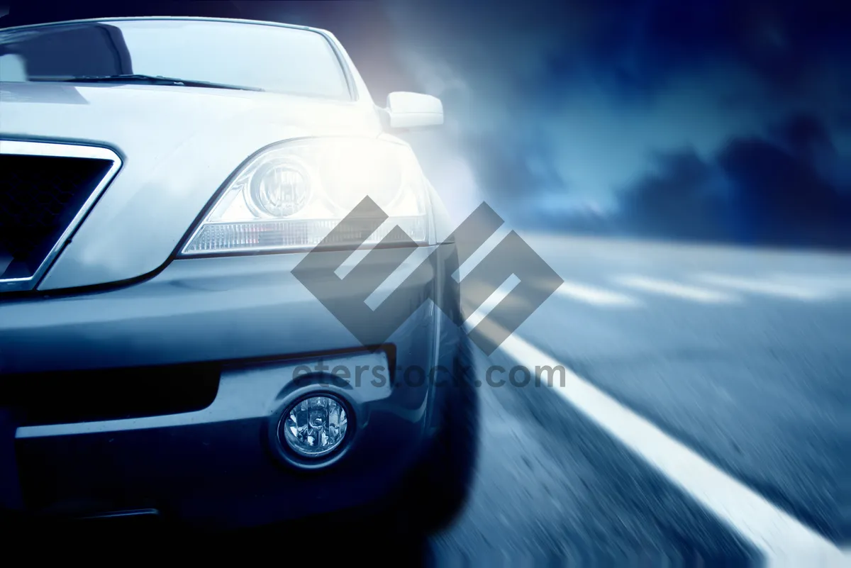 Picture of Speedy modern luxury car on highway at night.