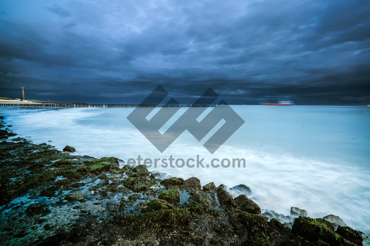 Picture of Sunset over rocky beach and wave