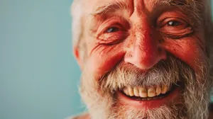 Happy elderly man wearing a crazy mask and smiling