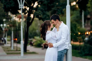 Happy Couple Smiling Together in Park at Sunset