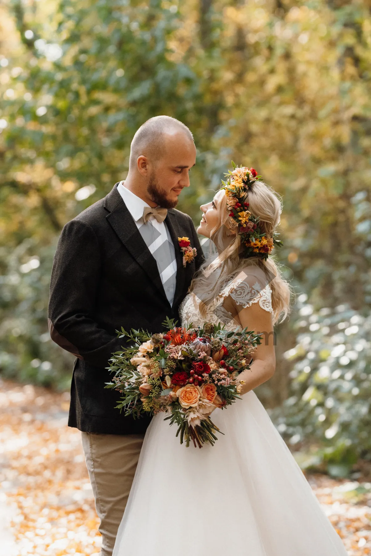 Picture of Happy couple celebrating their romantic wedding outdoors with flowers.