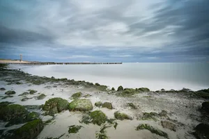 Tranquil beach scenic with waves and clouds