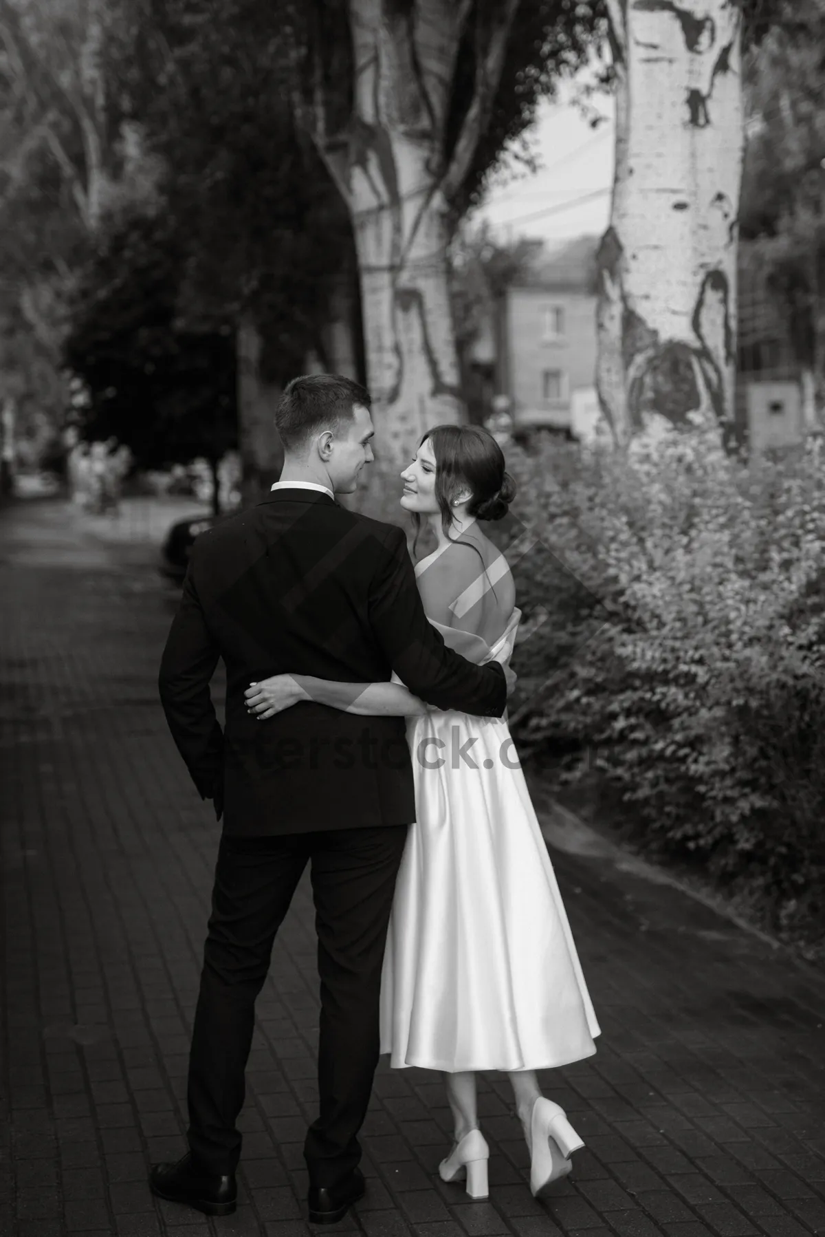 Picture of Happy groom and bride in wedding gown holding bouquet