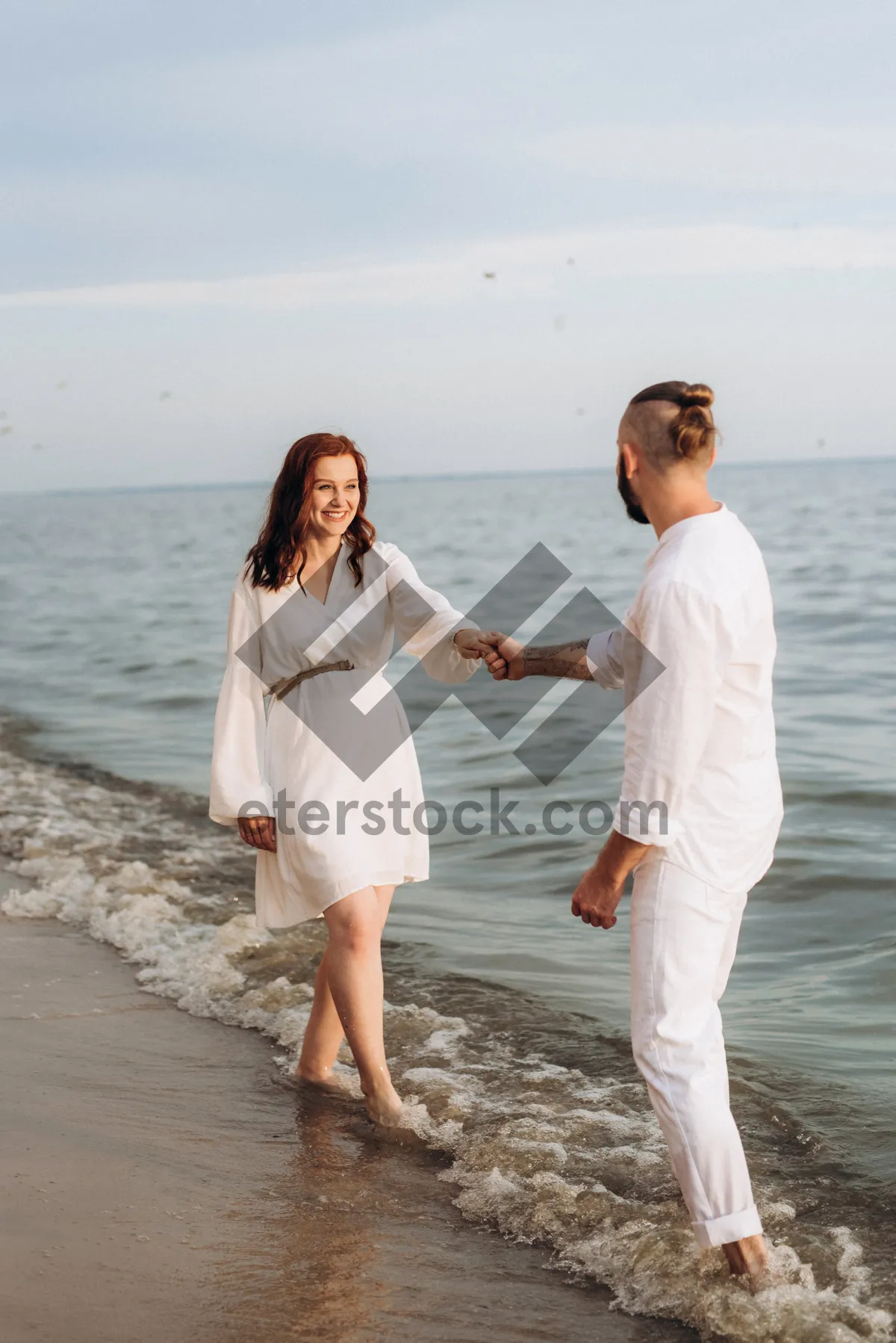 Picture of Happy family walking along the seaside beach together.