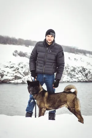 Man and dog in winter mountain fun