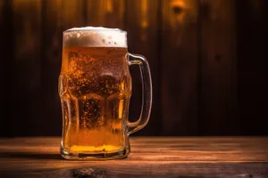 Golden beer in frosted glass with bubbles.