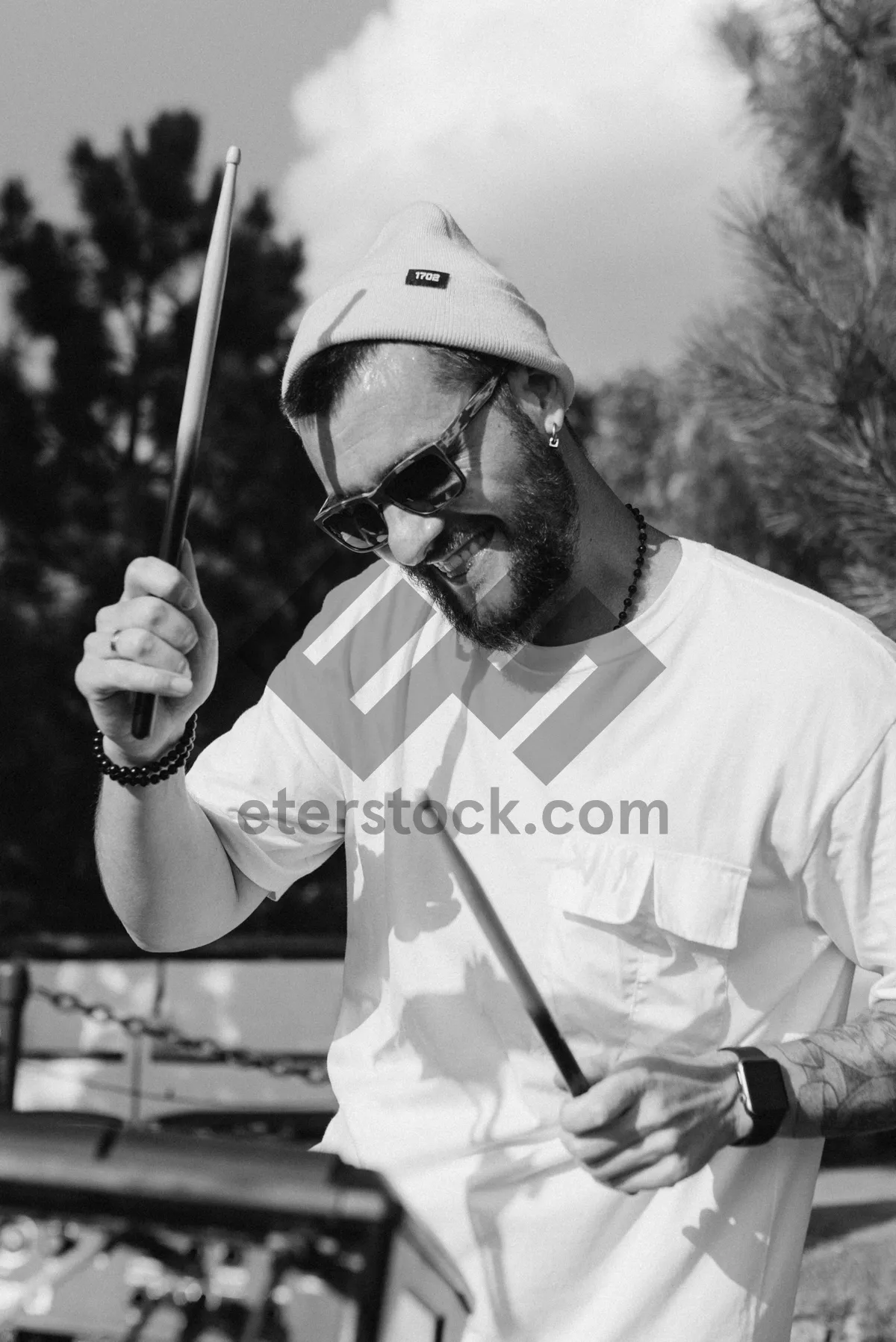 Picture of Dynamic male golfer swinging iron club on green course