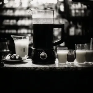 Glass coffee pot on kitchen counter top with cup