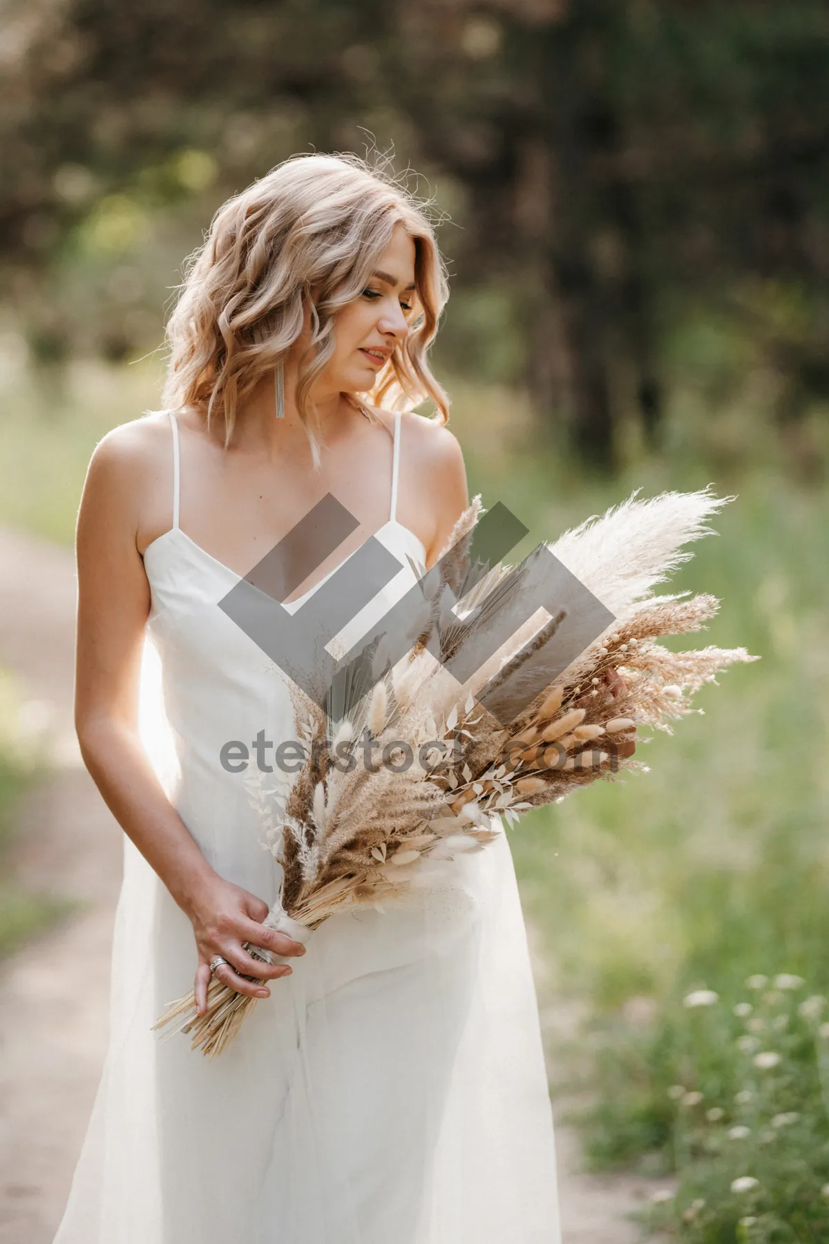 Picture of Attractive Blond Bride Smiling in Summer Park Portrait