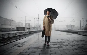 Male with Umbrella in Trench Coat on Street