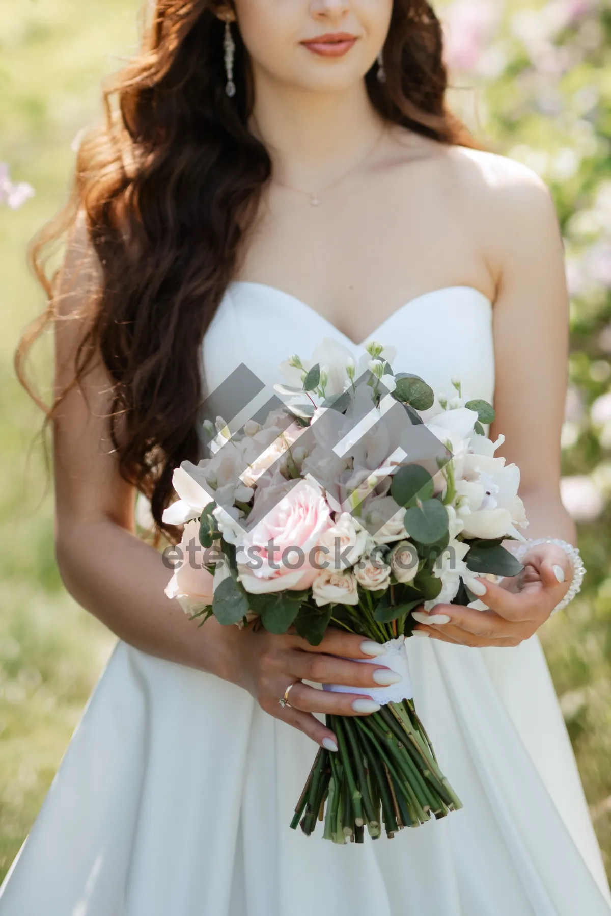 Picture of Happy wedding couple with floral bouquet