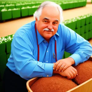 Happy male office worker smiling while working on laptop