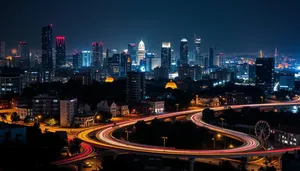 Modern city skyline at night with reflections in water.