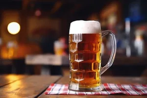 Golden beer in frosted glass with bubbles.