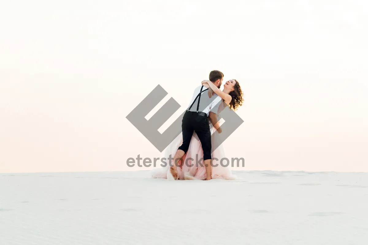 Picture of Happy newlywed couple smiling on beach vacation.